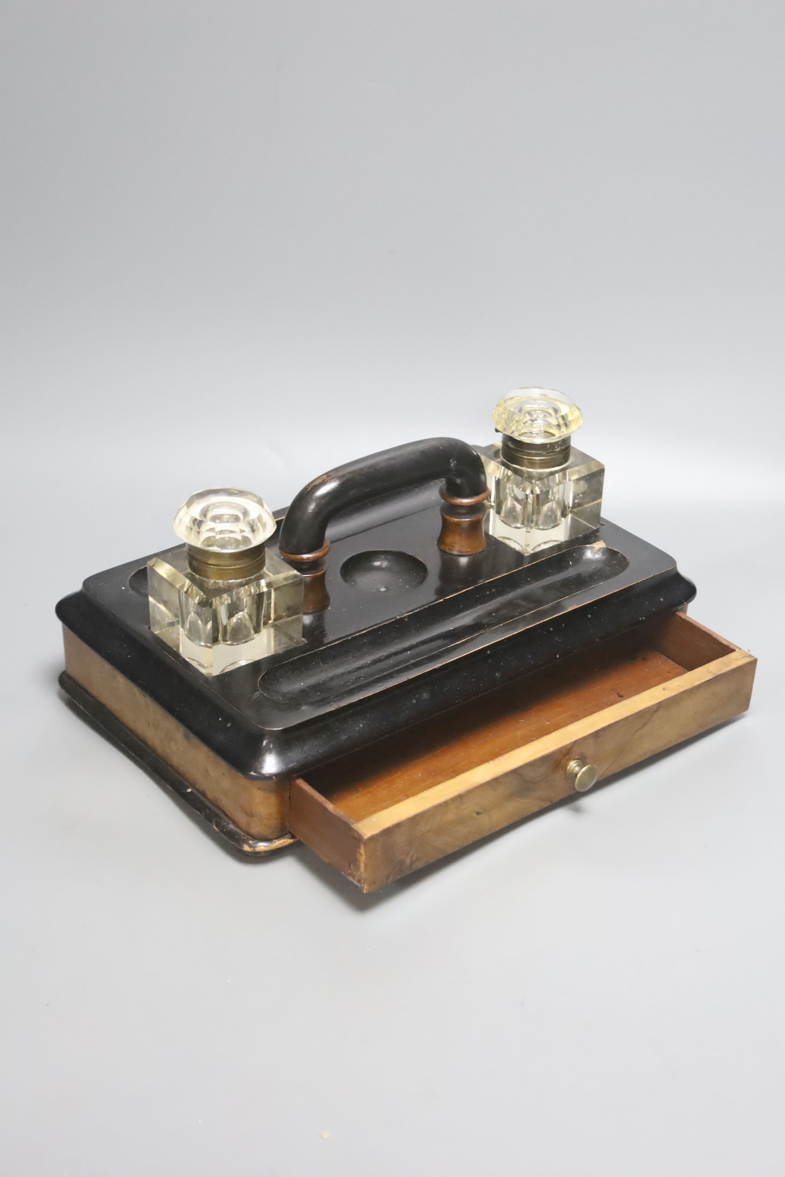 A Victorian walnut and ebonised desk stand with single drawer, 30cm wide together with a framed Continental porcelain portrait miniature